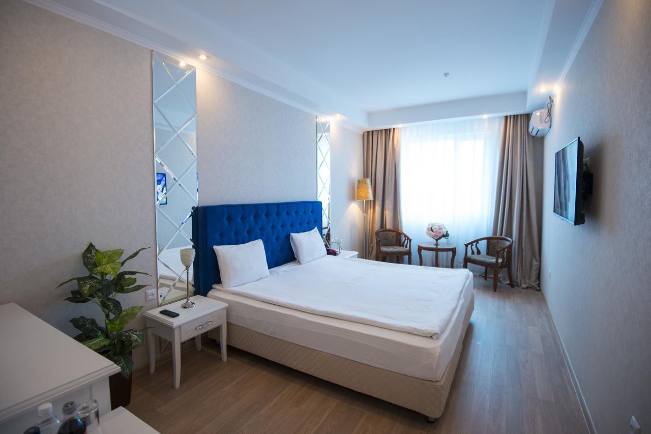 Akbulak Hotel Astana Bagian luar foto